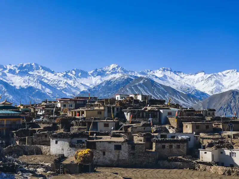 Houses below snow mountains in Kinnaur.