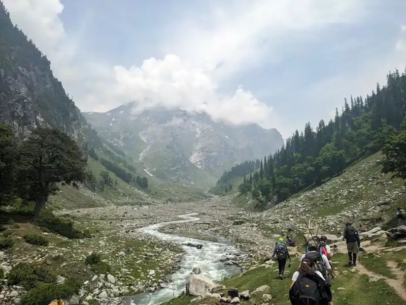 Walking up a green hillside on the way to the pass.
